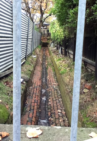 Gazebo at the corner of the bricked creek