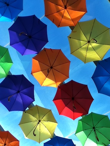 Lots of Umbrellas in sunny winter Mall